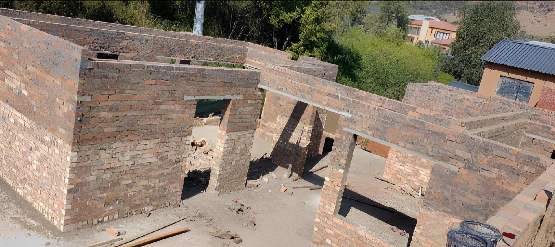 Face-brick internal walls and door openings of a house at wall-plate level