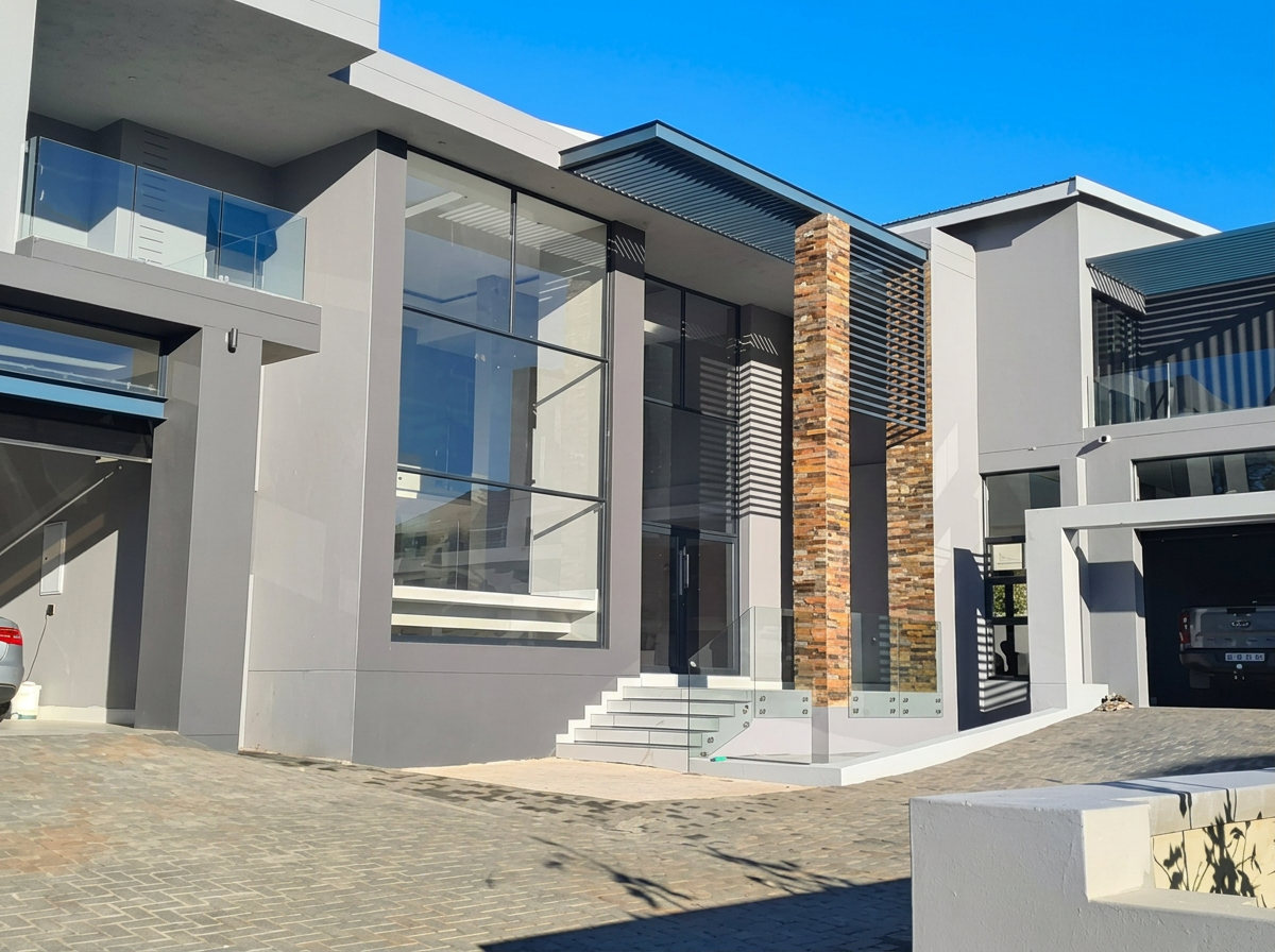 Completed modern residence with stone cladding and glazed facade
