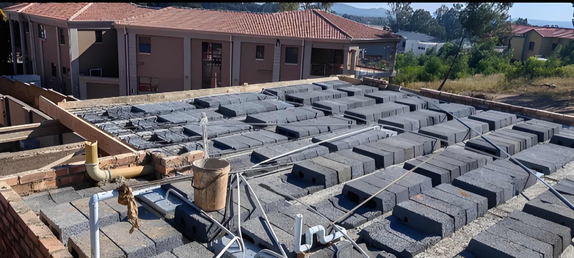 Suspended slab under construction with plumbing services routed below on a Ramusia site
